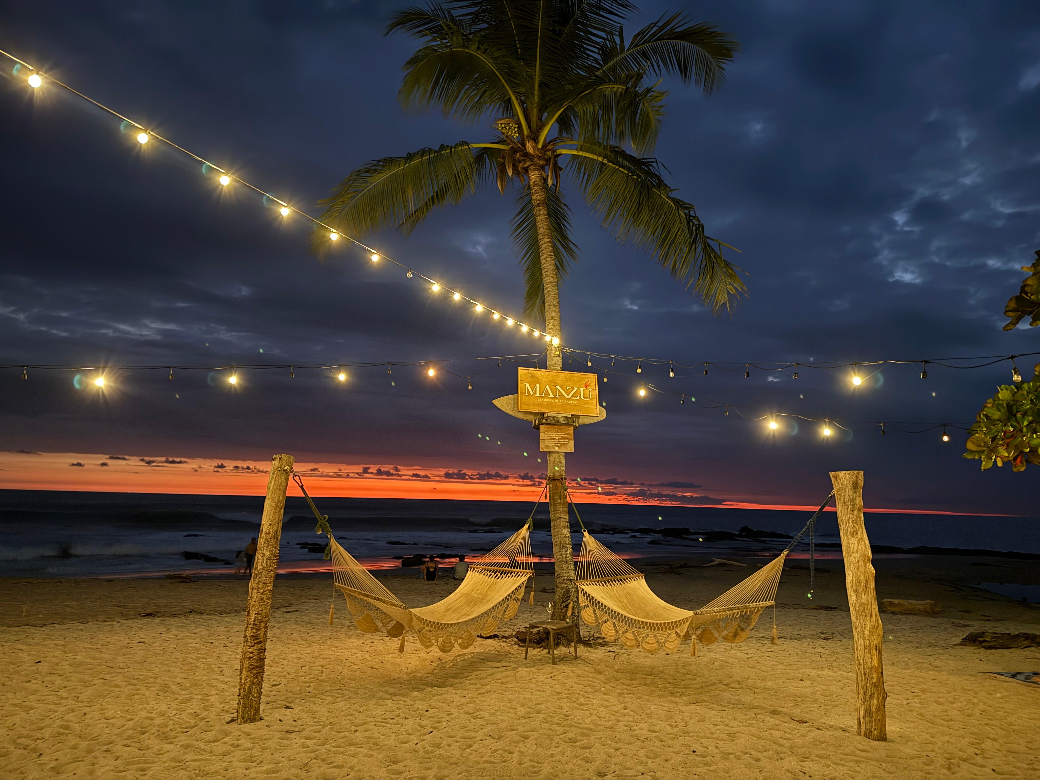 hammocks under the palm tree at night at the beach